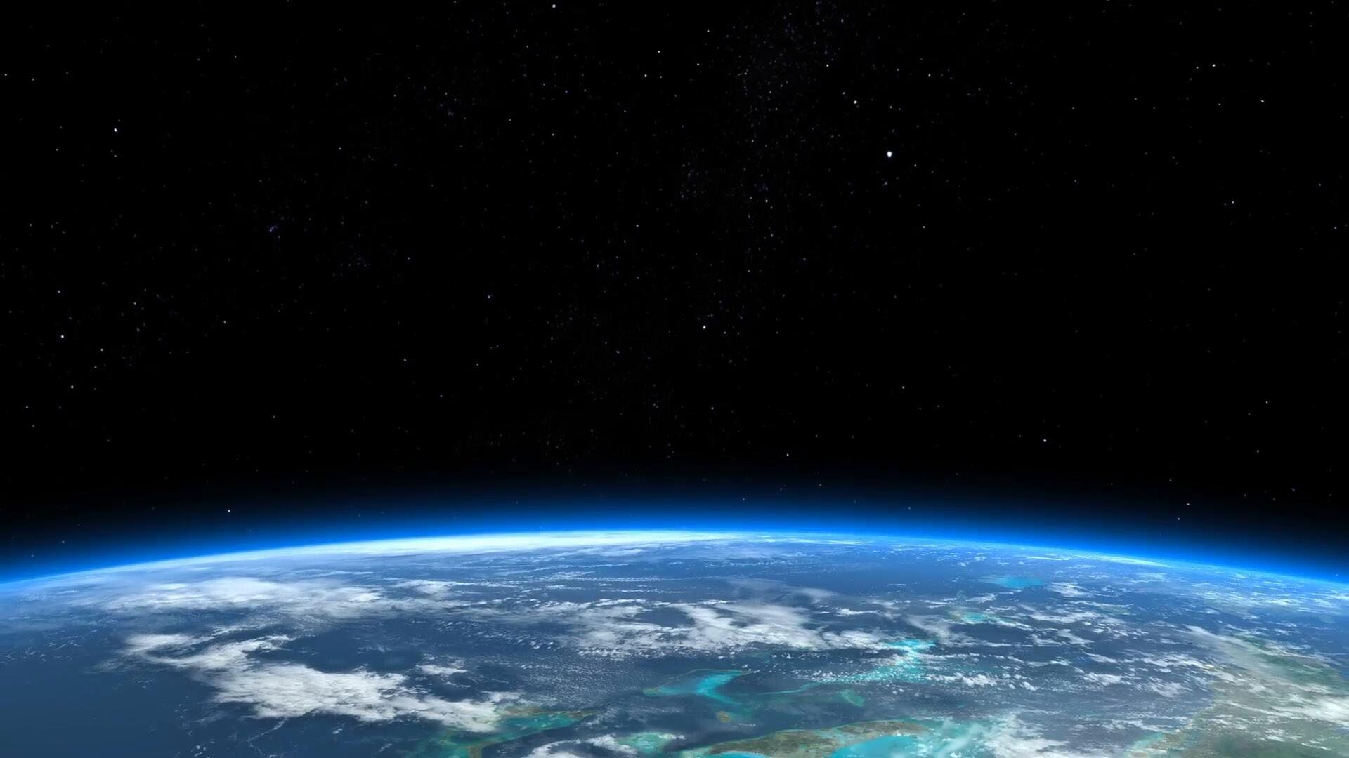 La Tierra vista desde la órbita, con la curvatura terrestre y un halo atmosférico azul contra el cielo estrellado